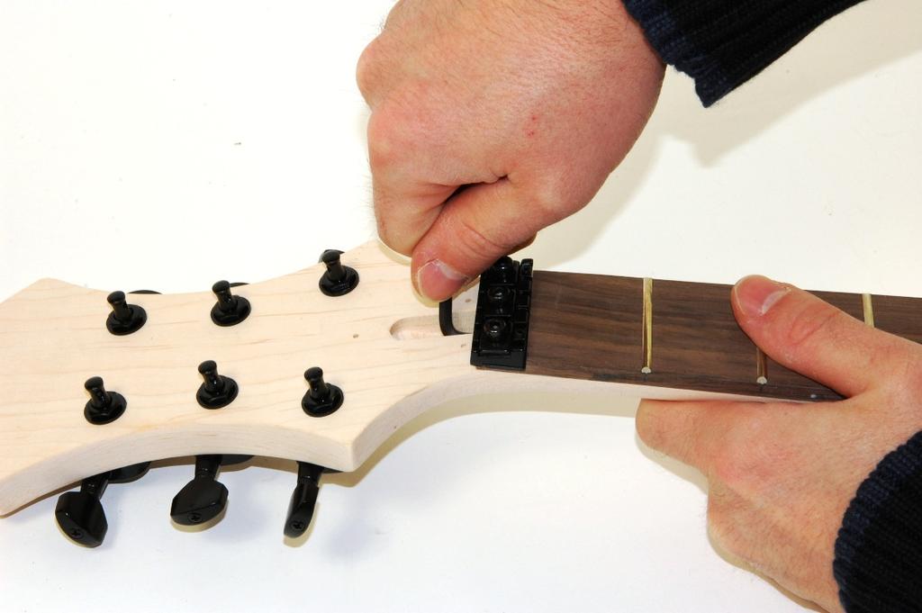Adjusting of the truss rod and clearing the fret intonation After tuning your guitar correctly you will possibly recognize that the neck is not straight enough. Potentially it is introversive.