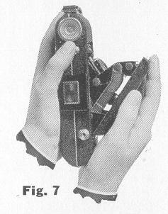 BEFORE closing the Kodak, adjust the focus for infinity. The reflecting finder must be in the upright position; then press the same button that is used to open the Kodak (Fig.