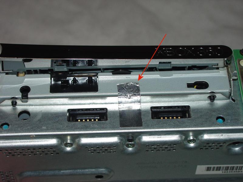 Step 9 At the front of the DVD drive, peel back the end of the tape shown