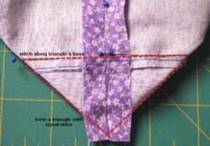 Once satisfied, pin in place and stitch along the seamed line at the base of the formed triangle.