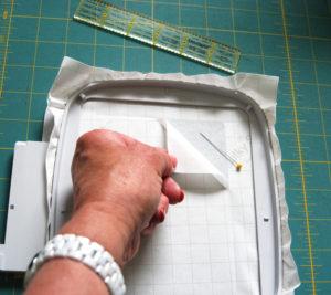 Lightly score the protective paper with a pin and peel it away, exposing the stabilizer s sticky surface.