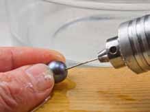 Hold the pearl by its sides while drilling to prevent puncturing your finger.