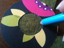 8. Neatly cut a circle of felt the same size as your plastic ring - you can use the hole