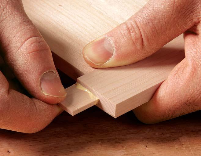 Before cutting the dovetails, cut the keeper slot at the router table. Then, at the tablesaw, cut the groove for the bottom and the dado for the back.