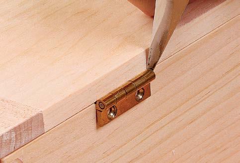 Then apply a dab of glue at the center of the tongue, re-clamp, being sure that the center holes align perfectly, and drive 1 8-in. cherry dowels through the holes.