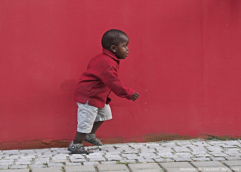 I took this picture in Nantes, in western France. This photo is a good example of anticipation. I noticed a little boy, from a distance, who was walking with his grandmother near this red wall.