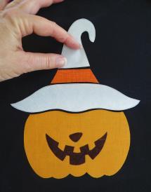 What You Will Need (1) black t-shirt A scrap of bright orange fabric for the pumpkin A scrap of deep orange fabric for the hat-band A scrap of darkest brown-black fabric for the pumpkin s face Small