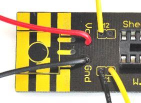 The black wire goes into the hole labeled Gnd and the red wire goes into the hole labeled Vcc as shown. 13.