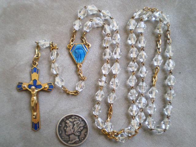 The center is different from most rosaries like this, as it has an image of Mary on the front and The Sacred Heart of Jesus on the reverse in enamel.