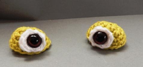 Then pin the eyes to the head and sew them.