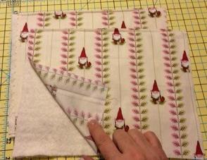 Line up the folds of the fabric with a line on your mat and