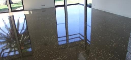 The act of changing a concrete floor surface, with or without aggregate exposure, to
