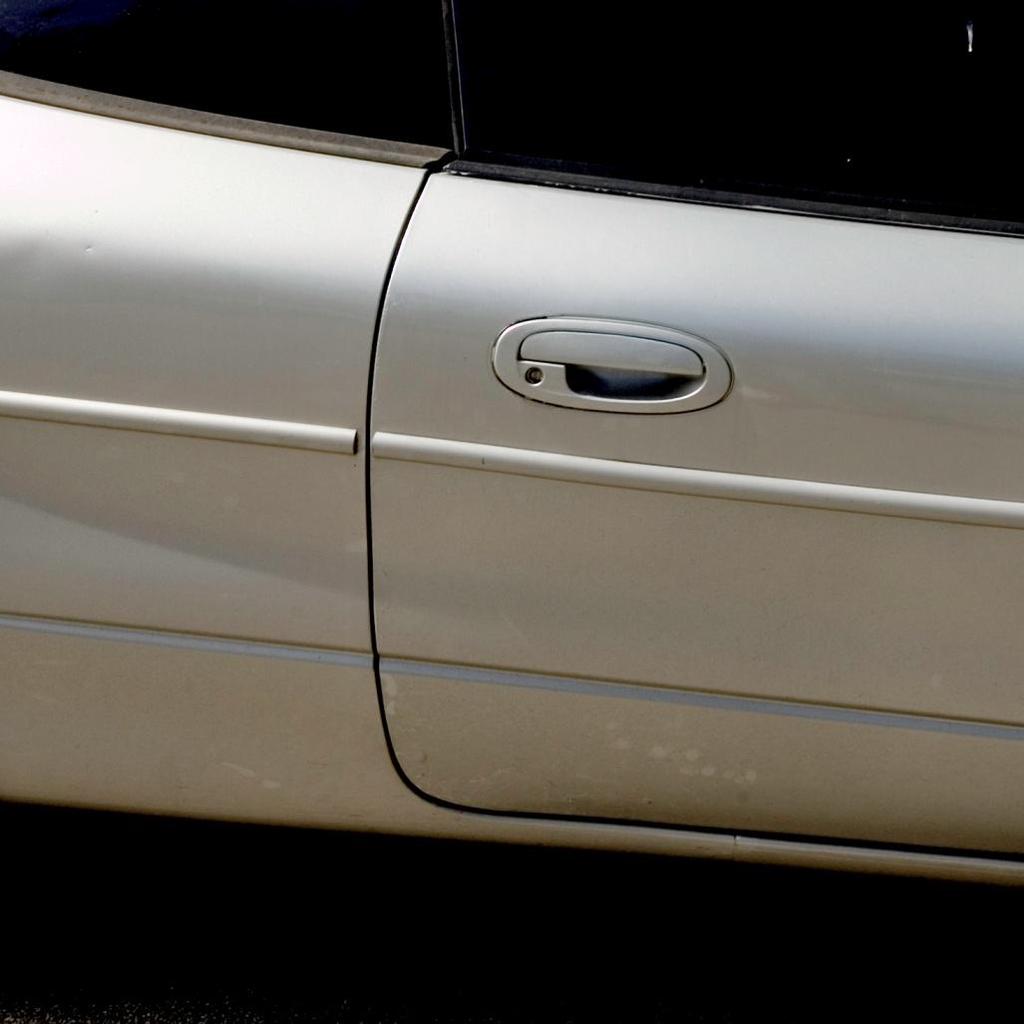 White car door looks normal to the eye uniform tonality