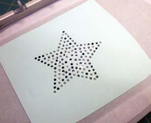 Cut a piece of rhinestone template material slightly larger than the design.