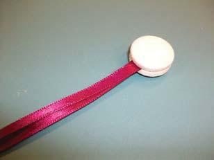 Glue both ribbon ends between a matched pair of shankless decorative buttons, or standard
