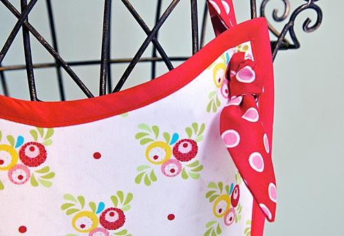 Place a horizontal buttonhole at each waist corner with the side just below the bias tape and the top approximately ¼" in from the bias tape. 11.