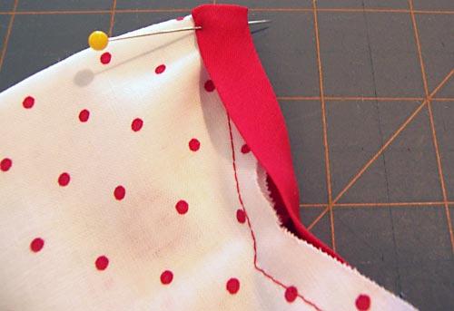 Turn the extra ½" ends toward the pocket lining at each side and pin in place. 10.