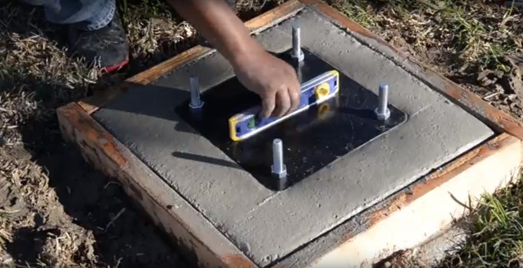 Place the assembled anchor system in hole to the point where the bottom of the black anchor plate (G) is flush with the top of the finished concrete.