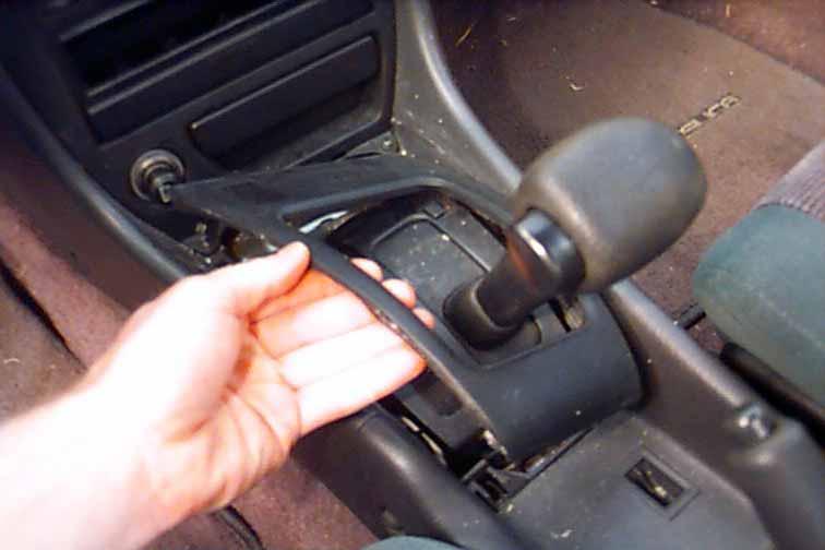 Factory Radio STEP 1: With your hands, gently lift up and unsnap the plastic panel surrounding the gear shift area.