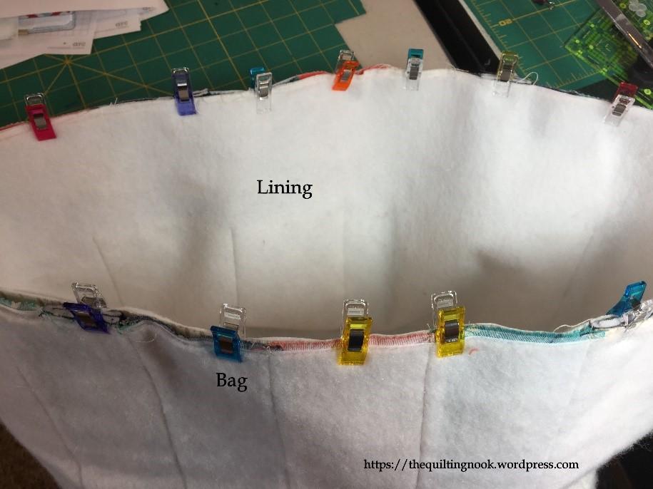 To create the boxed corner, pinch the bottom seam and side seam together. Use the clips to hold the pieces together.
