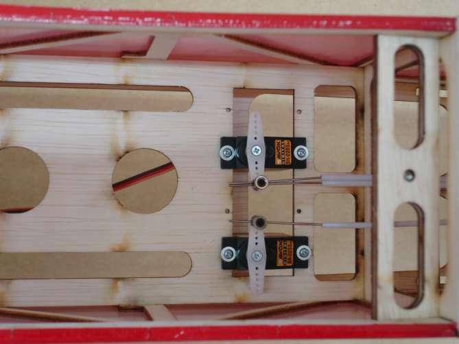 Drop some instant glue onto the servo securing holes on servo tray for reinforcing the
