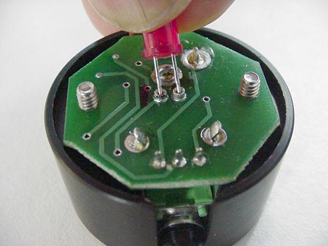 Illumination level is controlled with the knob. Figure 5: a) Removing the LED lamp housing; b) replacing the LED.