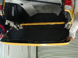 Lift the rear half of the tonneau cover and hold over the bed of the truck.