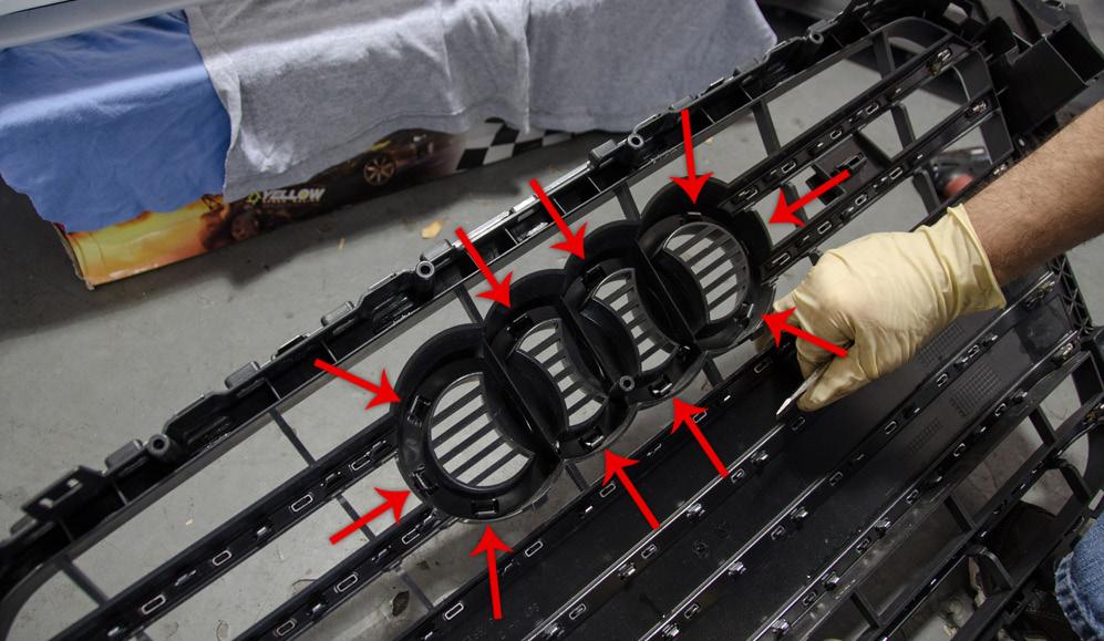13. Remove the factory grill by releasing the retaining tabs. 14.