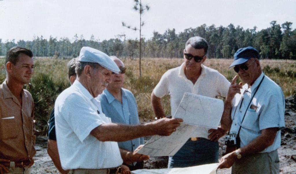Surveyor Bill Hart (left) with Walt Disney and other Disney executives as they plan the development of Walt Disney World. Photo courtesy Bill Hart, Jr. ill Hart had seen the type before.