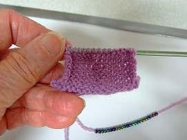 The one nice thing about this method is that the beads are exactly where they need to be and if they need a bit of alignment, that can be done very nicely with one ply of the yarn and a sewing needle.