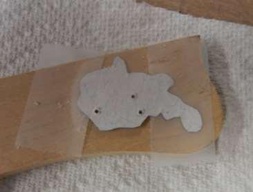 Locate and tape the template onto your wood (best on the front side to avoid
