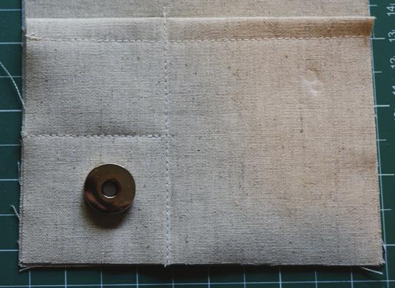 Stitch a vertical line ½ distance from magnetic clasp from the bottom of the pocket to ¼ above the pocket hemline.