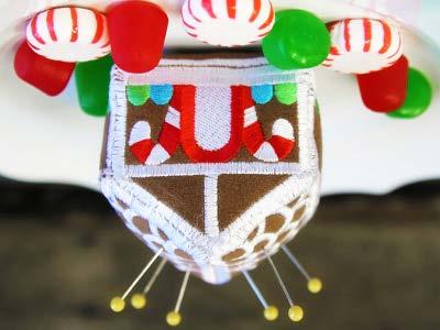 A gingerbread house pincushion makes a festive accessory as you stitch all those holiday projects.