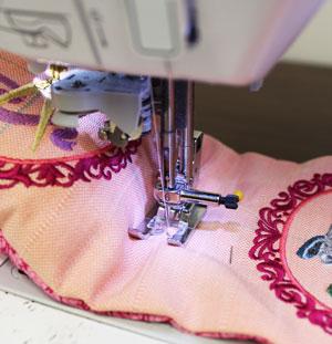 Then, push the fiberfill to the side away from the first seam and pin the layers of fabric in place. Sew a one inch long seam in the center of the existing seam.