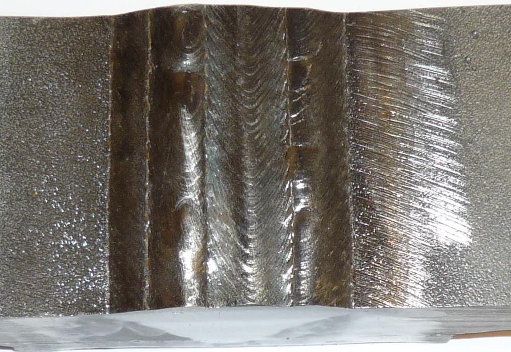 0 Etched cross-section of a multipass weld in overhead 4G position.