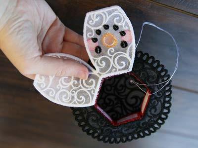 Use a hand sewing needle or hot glue, and tack it into place.