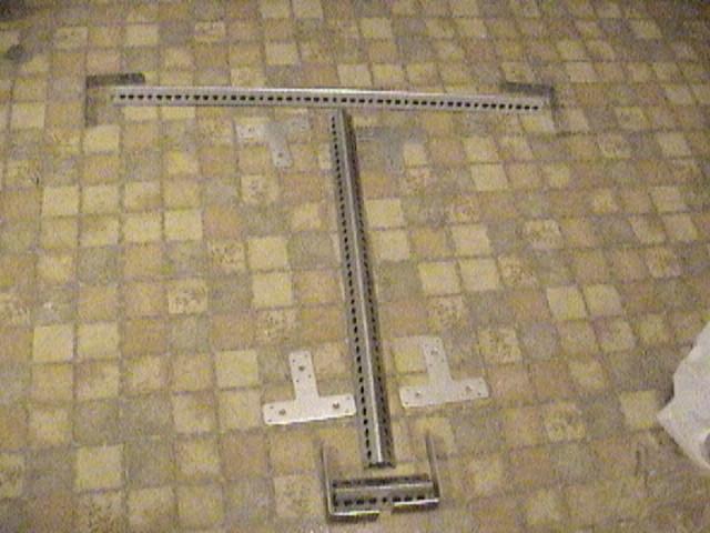 The main components in this dolly design are 4 metal Tees and 4 metal 90º bends (found in or near the lumber section of a hardware store), and two 3' slotted L-shaped metal bars (found in metal