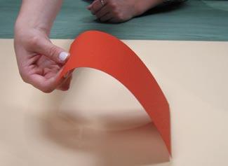 Start with the Great Outdoors Red Plain paper from Club Scrap. Hold the short side with your thumb and forefinger.