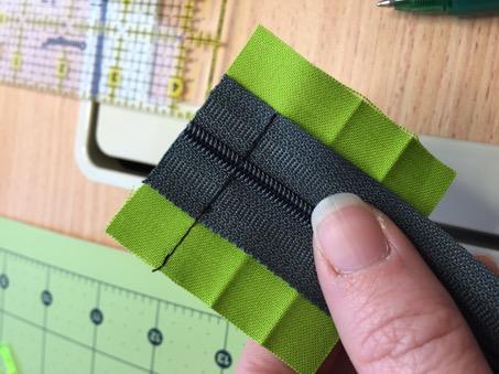 On unfinished end of zipper, make a mark on the zipper tape just inside the mark of exterior