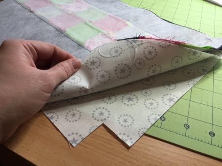 Next, place your second lining fabric right side up, and place the bag on top, lining up edges and pin.