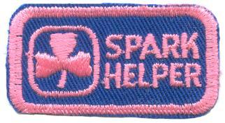 Spark Helper Badge 1. X1033 2. POR (1993) 3. 1993-4. Rectangle; blue; cotton: Trefoil, text SPARK HELPER and edging in pink stitching.