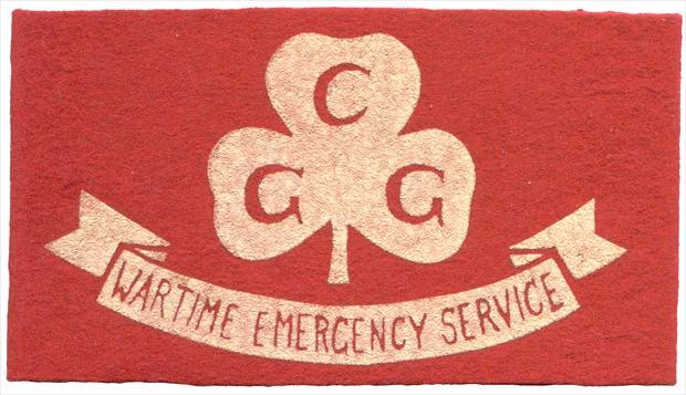 Wartime Emergency Service Armlet 1. X1042 2. Canadian Guider (May 1942) 3. 1942-1945 4. Red felt; with text WARTIME EMERGENCY SERVICE on white banner with white Trefoil above and text CGG.