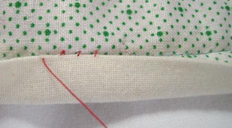 Make two or three more stitches, being sure to insert the needle into the backing right next to where it emerged from