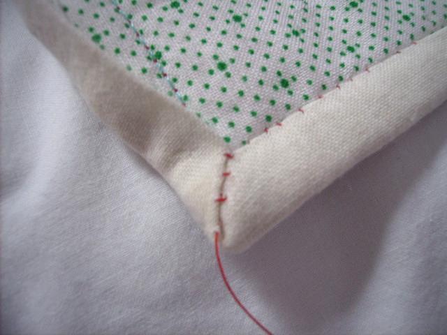 When you arrive at the corner, be sure the binding is folded as accurately as possible and take an extra stitch in the edge of