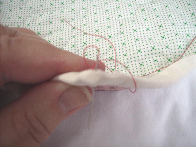 13. Taking a tiny stitch, insert the needle from the back