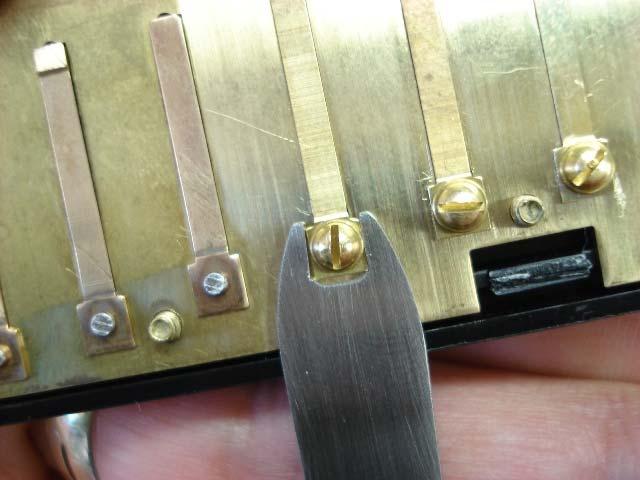 In the event the reed clicks and clacks against the reed plate, use the reed wrench end of the reed support tool to re-center the reed within the slot.