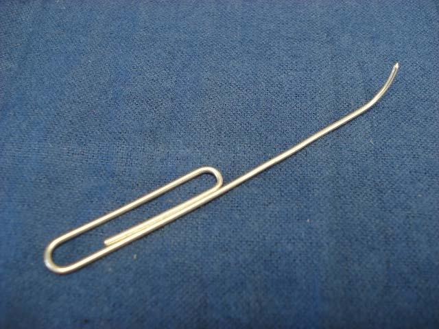 Your eyes are not deceiving you, it is a modified paper clip, and as a reed