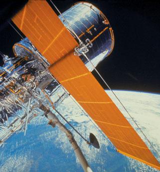 FIGURE 25 32 Hubble Space Telescope, with Earth in the background. The flat orange panels are solar cells that collect energy from the Sun to power the equipment. EXAMPLE 25;0 Hubble Space Telescope.