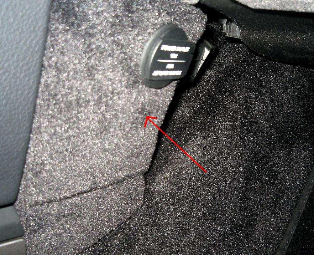 9. For cars without the Bose speaker system, in the driver foot well, use the T-25Torx to remove the screw that holds the small trim panel in. The screw is hidden in the pile.