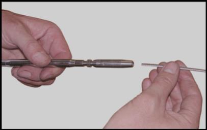Attaches to cable using wedges that are inserted manually and locked with a conical nut.